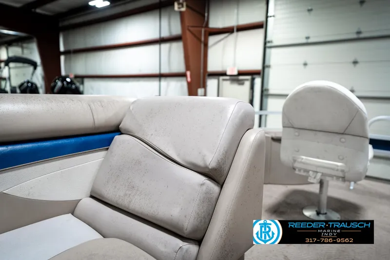 Slide: The Image of 2011 Bennington 20 SFI boat interior with beige seating in a garage setting. - 24