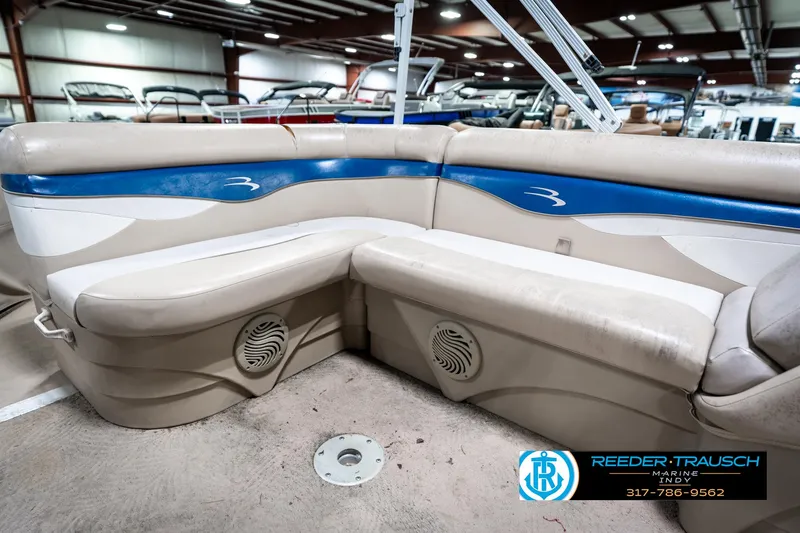 Slide: The Image of 2011 Bennington 20 SFI boat interior with beige and blue seating in showroom. - 27