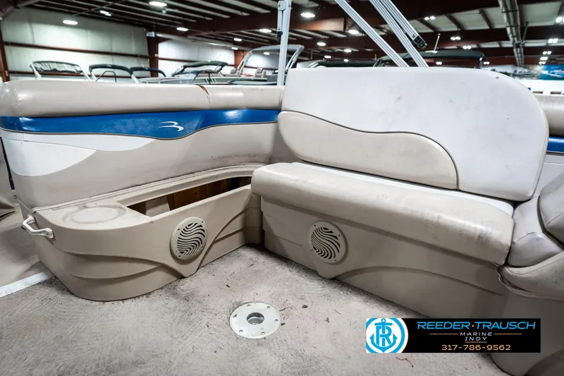 Slide: The Image of Interior of a 2011 Bennington 20 SFI boat with beige seating and blue accents. - 29