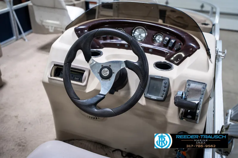 Slide: The Image of 2011 Bennington 20 SFI boat dashboard with steering wheel and control panel. - 32
