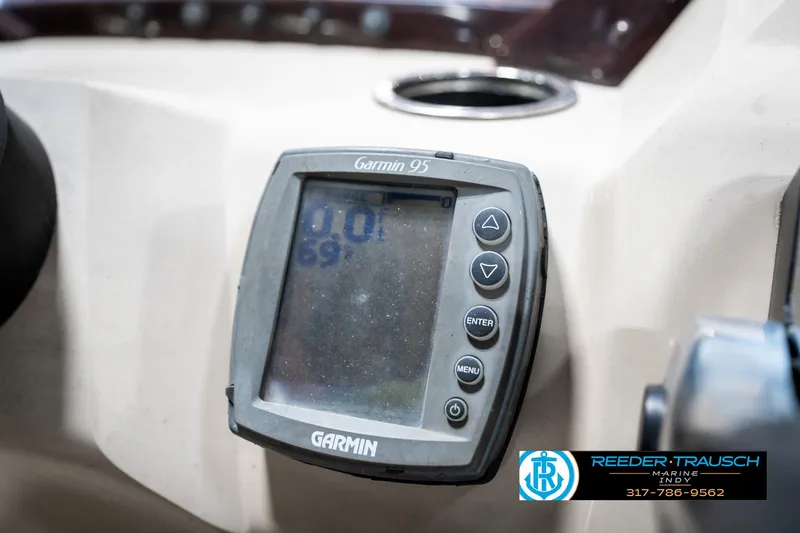 Slide: The Image of Garmin GPS device on 2011 Bennington 20 SFI boat dashboard, featuring control buttons. - 38