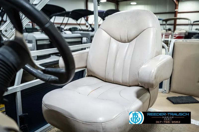 Slide: The Image of 2011 Bennington 20 SFI boat seat in showroom, featuring beige upholstery and steering wheel. - 39