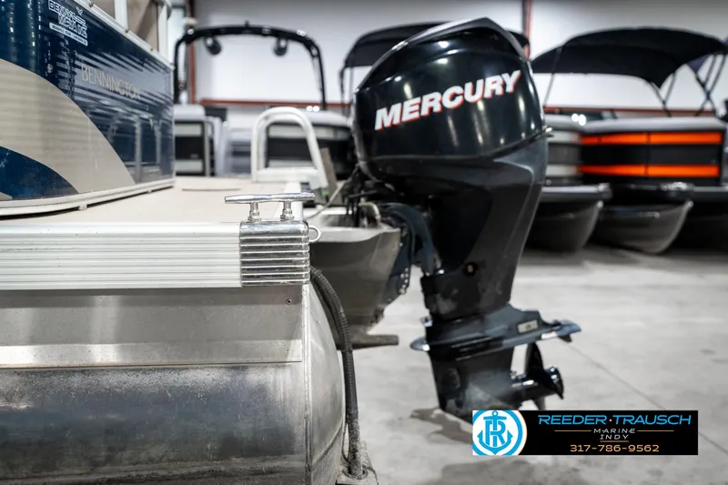 Slide: The Image of 2011 Bennington 20 SFI pontoon boat with Mercury outboard motor in showroom. - 44
