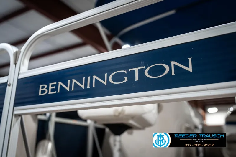 Slide: The Image of 2011 Bennington 20 SFI boat with visible branding in a showroom. - 48