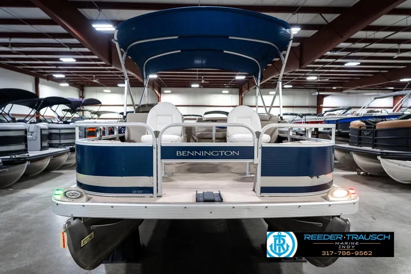 Slide: The Image of 2011 Bennington 20 SFI pontoon boat in indoor showroom, blue and white design. - 5