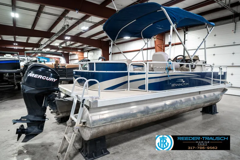 Slide: The Image of 2011 Bennington 20 SFI pontoon boat with Mercury outboard in indoor storage. - 8