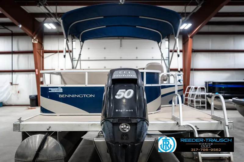 Slide: The Image of 2011 Bennington 20 SFI pontoon boat with 50 HP engine in a warehouse. - 9