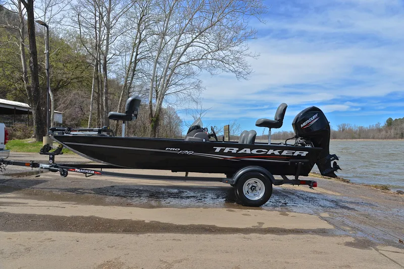 Slide: The Image of 2023 Bass Tracker Pro 170 boat on trailer by a lake. - 11