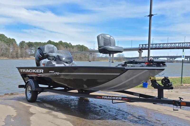 Slide: The Image of 2023 Bass Tracker Pro 170 boat on trailer by a lake. - 16