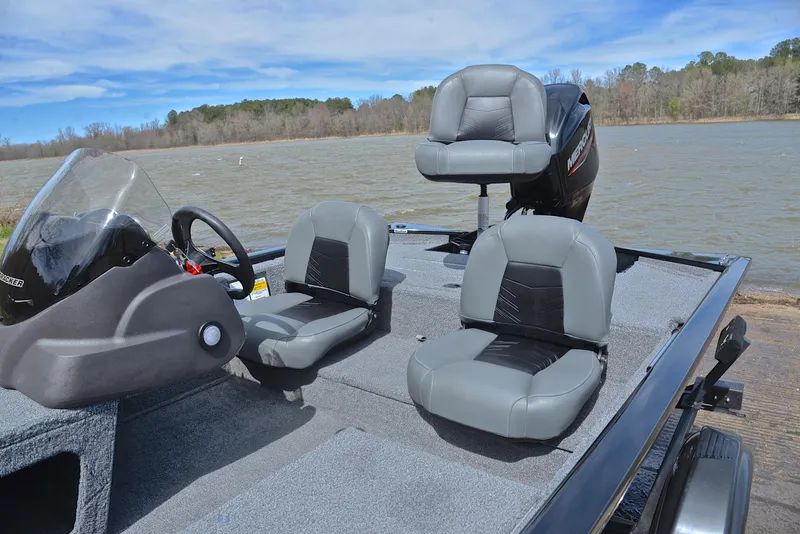 Slide: The Image of 2023 Bass Tracker Pro 170 boat with gray seating on a lake. - 18