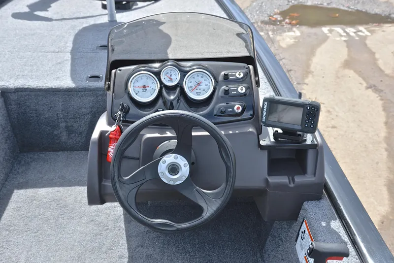 Slide: The Image of 2023 Bass Tracker Pro 170 dashboard with steering wheel and gauges. - 24