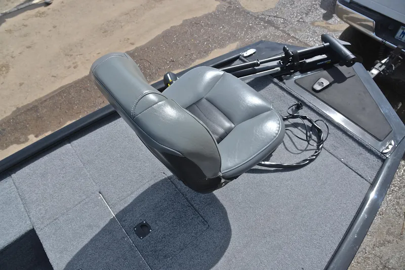 Slide: The Image of 2023 Bass Tracker Pro 170 boat seat and deck, featuring gray upholstery and carpeted flooring. - 25