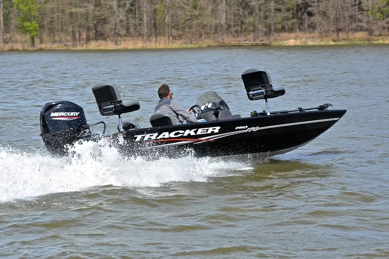 Slide: The Image of 2023 Bass Tracker Pro 170 boat speeding on a lake with Mercury engine. - 5