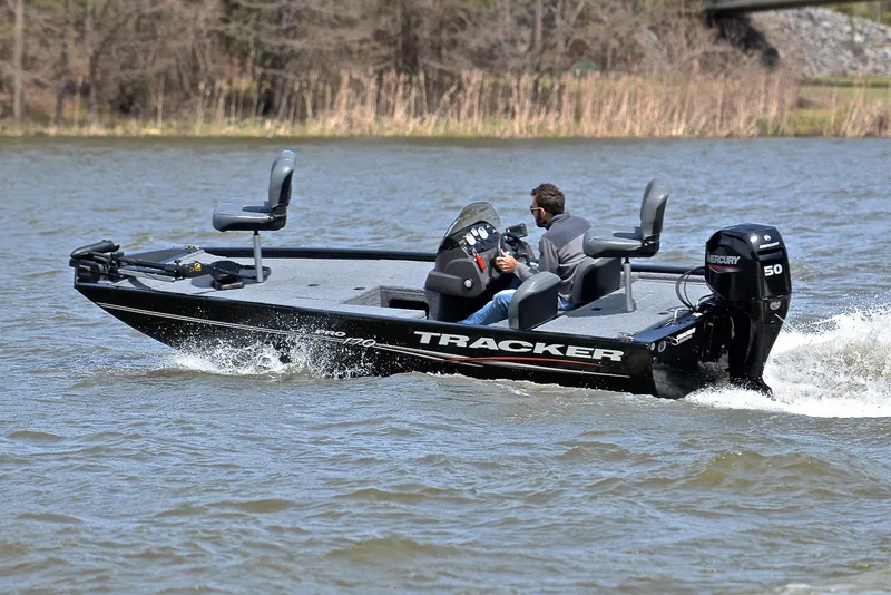 Slide: The Image of 2023 Bass Tracker Pro 170 boat cruising on a lake. - 6