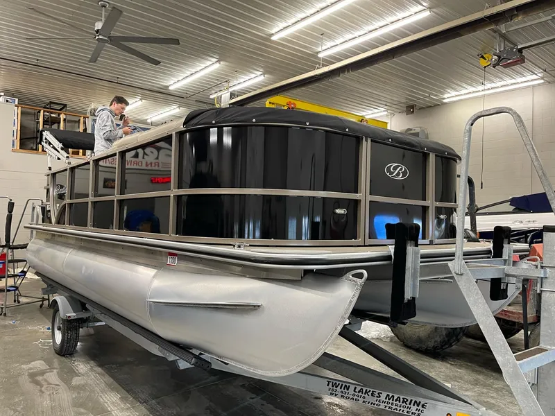 Slide: The Image of 2021 Bentley Pontoons Legacy 200 Cruise RE on trailer in indoor storage. - 0
