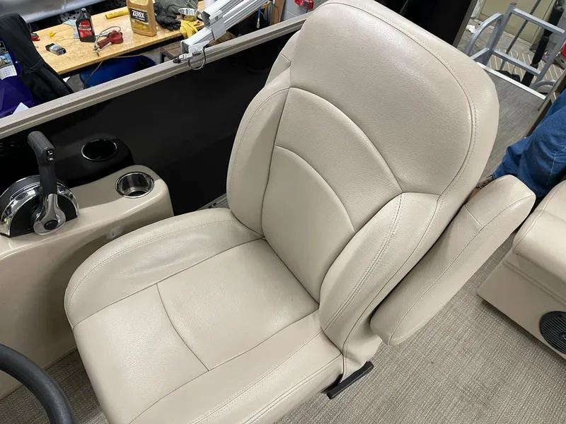 Slide: The Image of 2021 Bentley Pontoons Legacy 200 Cruise RE captain's chair with beige upholstery and cup holder. - 10
