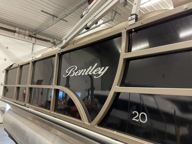 Slide: The Image of 2021 Bentley Pontoons Legacy 200 Cruise RE in a garage setting. - 2
