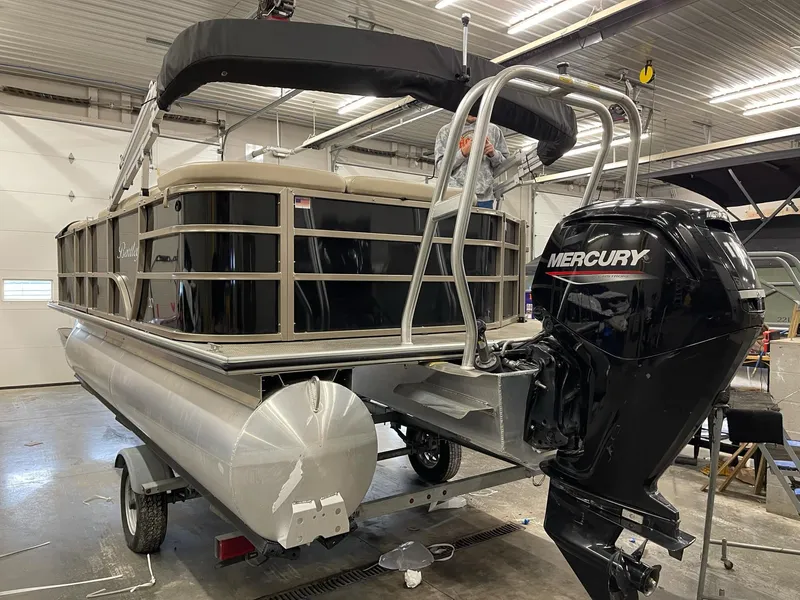 Slide: The Image of 2021 Bentley Pontoons Legacy 200 Cruise RE with Mercury outboard motor in a garage. - 3
