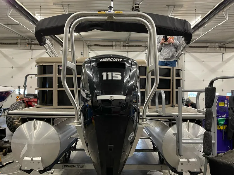 Slide: The Image of 2021 Bentley Pontoons Legacy 200 Cruise RE with Mercury 115 engine in a garage. - 4