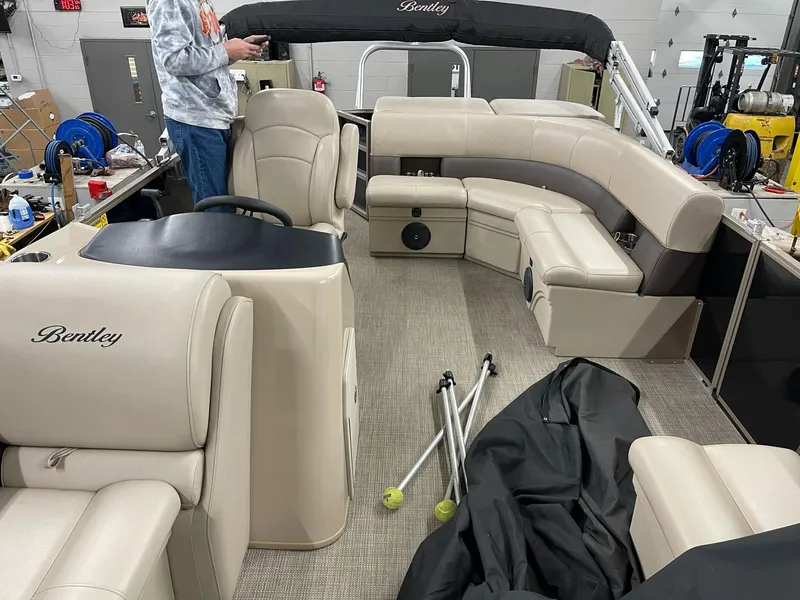 Slide: The Image of 2021 Bentley Pontoons Legacy 200 Cruise RE interior with beige seating and steering console. - 6