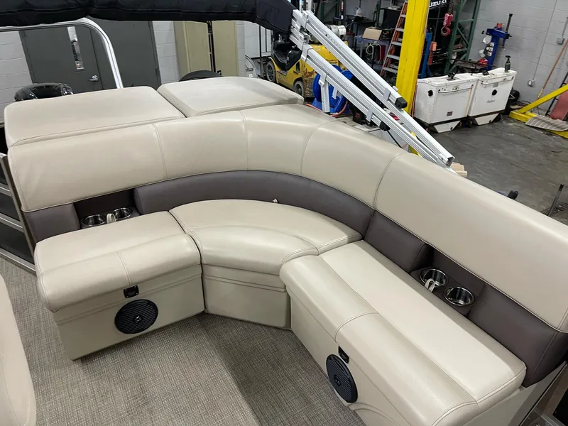 Slide: The Image of 2021 Bentley Pontoons Legacy 200 Cruise RE interior with beige seating and cup holders. - 9