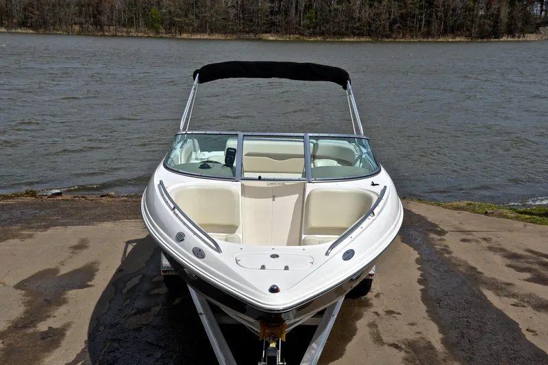 Slide: The Image of 2004 Chaparral 220 SSi boat on trailer by a lake. - 17