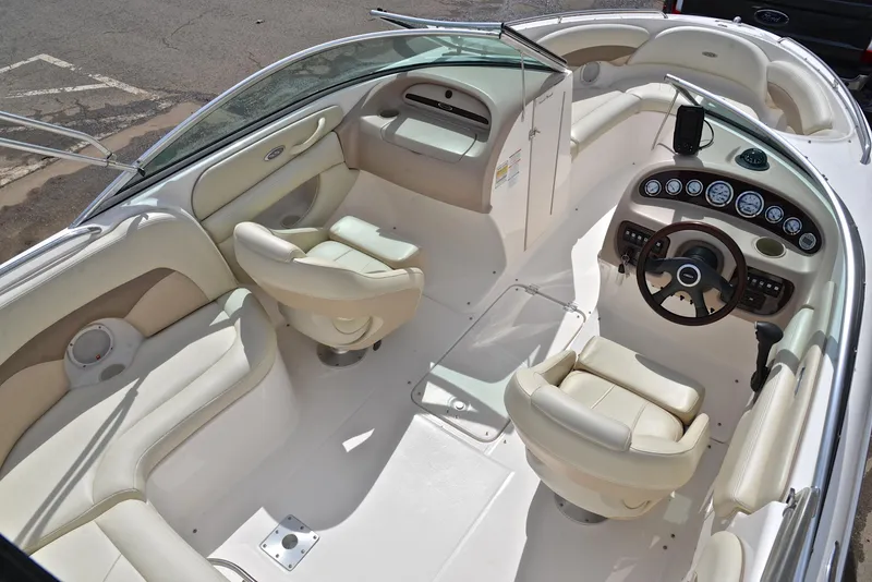 Slide: The Image of 2004 Chaparral 220 SSi boat interior with cream seats and modern dashboard. - 19