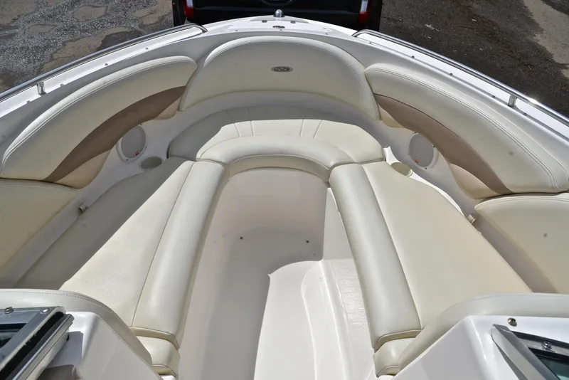 Slide: The Image of 2004 Chaparral 220 SSi boat interior with beige seating and spacious layout. - 21