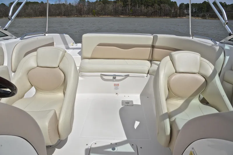 Slide: The Image of Interior of a 2004 Chaparral 220 SSi boat with white seating and open water view. - 22