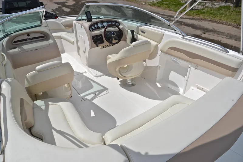 Slide: The Image of 2004 Chaparral 220 SSi boat interior with white seating and steering console. - 23