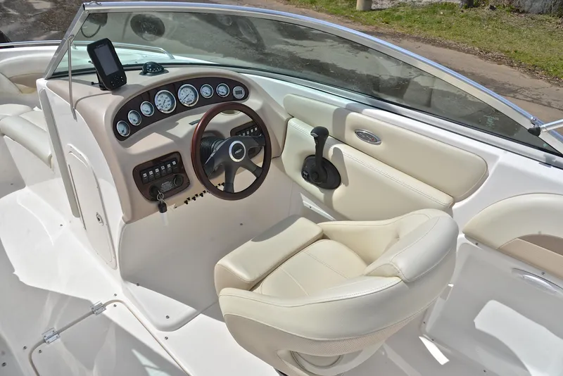 Slide: The Image of 2004 Chaparral 220 SSi boat interior with steering wheel and dashboard controls. - 24