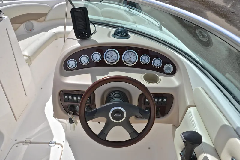 Slide: The Image of 2004 Chaparral 220 SSi boat dashboard with gauges and steering wheel. - 25