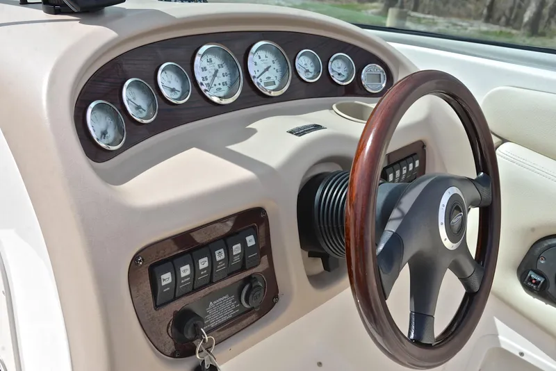 Slide: The Image of Dashboard of 2004 Chaparral 220 SSi boat with gauges and wooden steering wheel. - 26