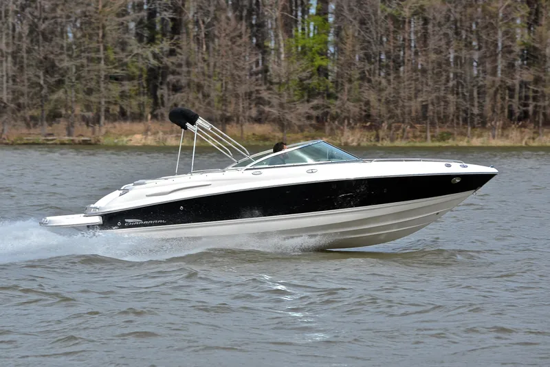 Slide: The Image of 2004 Chaparral 220 SSi speedboat cruising on a lake with forested background. - 3