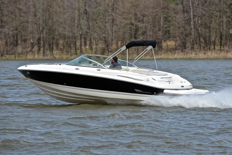 Slide: The Image of 2004 Chaparral 220 SSi boat cruising on a lake with trees in the background. - 4