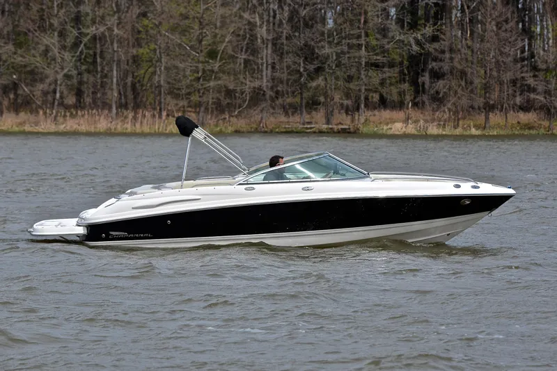 Slide: The Image of 2004 Chaparral 220 SSi boat cruising on a lake with forested background. - 7