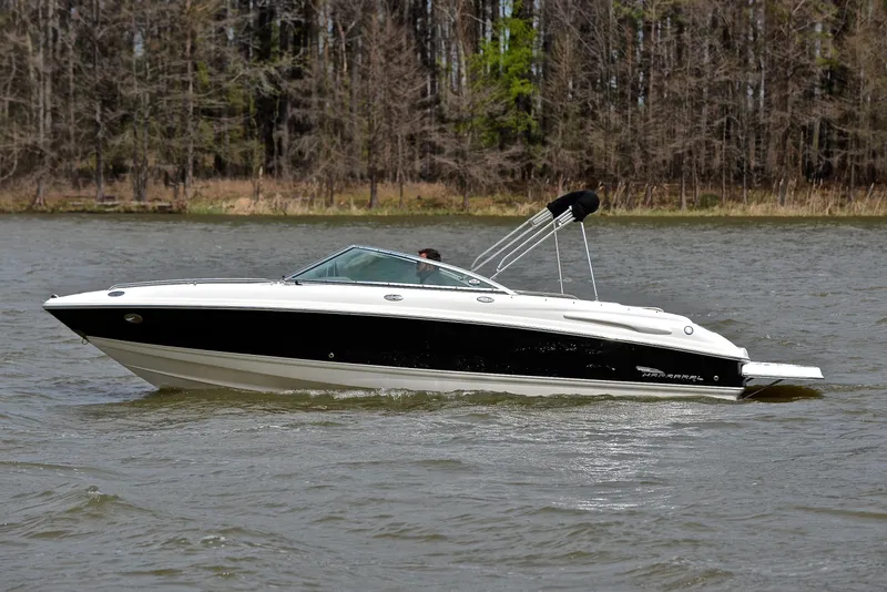 Slide: The Image of 2004 Chaparral 220 SSi boat cruising on a lake with forested background. - 9