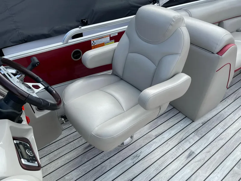 Slide: The Image of Captain's chair on 2016 Berkshire 233RFX STS pontoon boat, featuring sleek design and comfortable seating. - 12