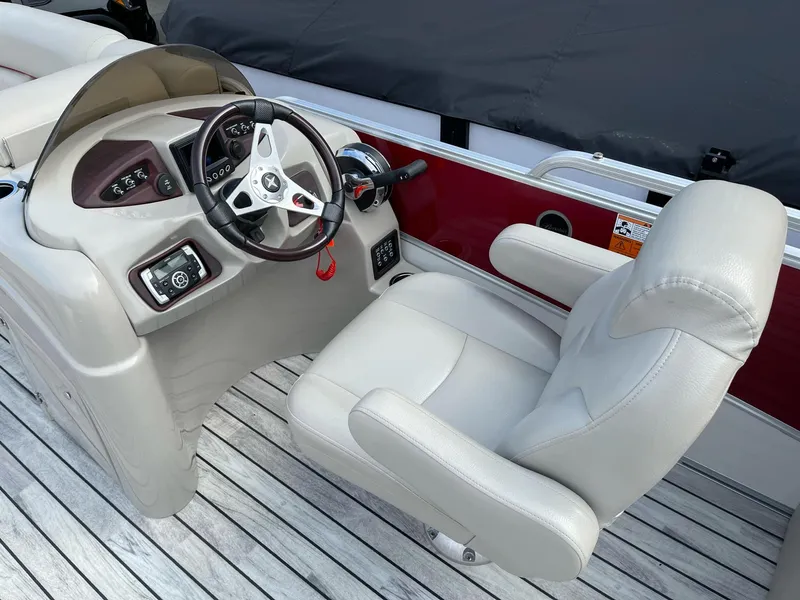 Slide: The Image of Captain's seat and helm of 2016 Berkshire 233RFX STS pontoon boat. - 13