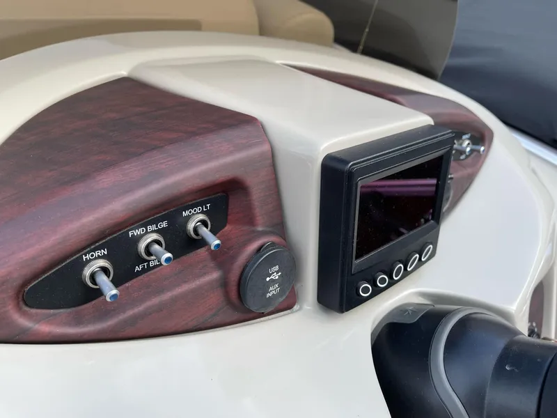 Slide: The Image of Control panel of 2016 Berkshire 233RFX STS boat with switches and display. - 16