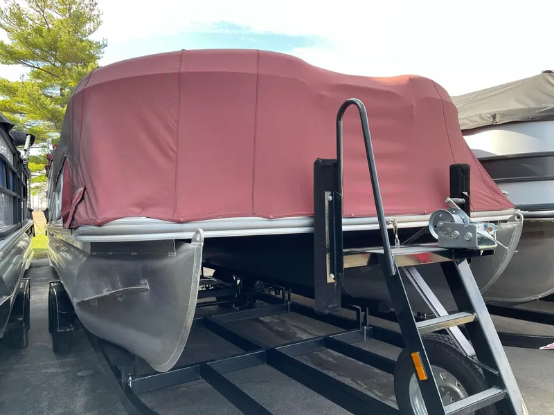 Slide: The Image of 2016 Berkshire 233RFX STS pontoon boat with maroon cover on trailer. - 22