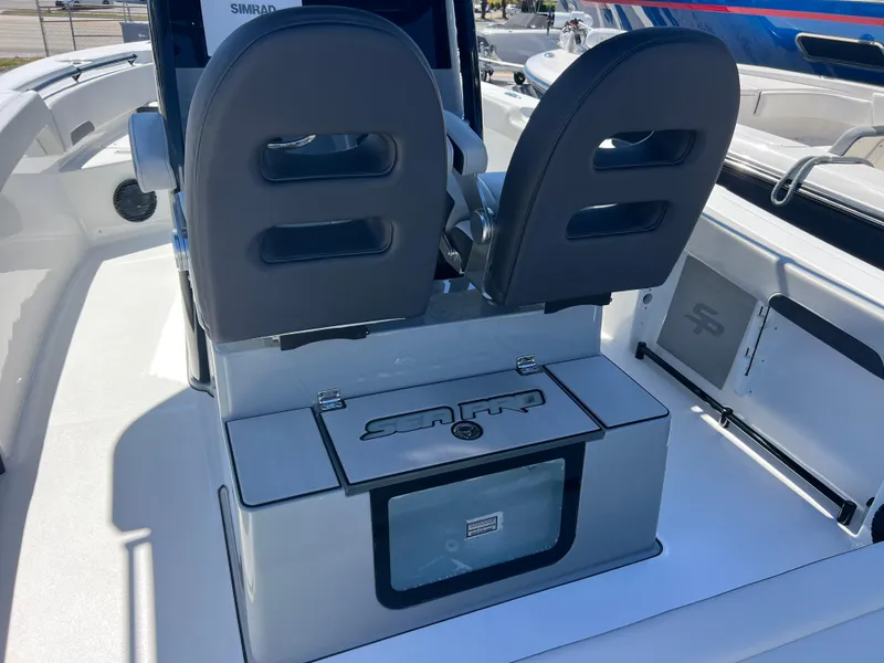 Slide: The Image of 2025 Sea Pro 245 FLX boat interior with dual seats and storage compartment. - 10
