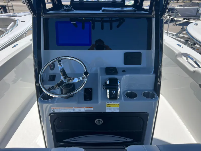 Slide: The Image of 2025 Sea Pro 245 FLX boat console with steering wheel and controls. - 12