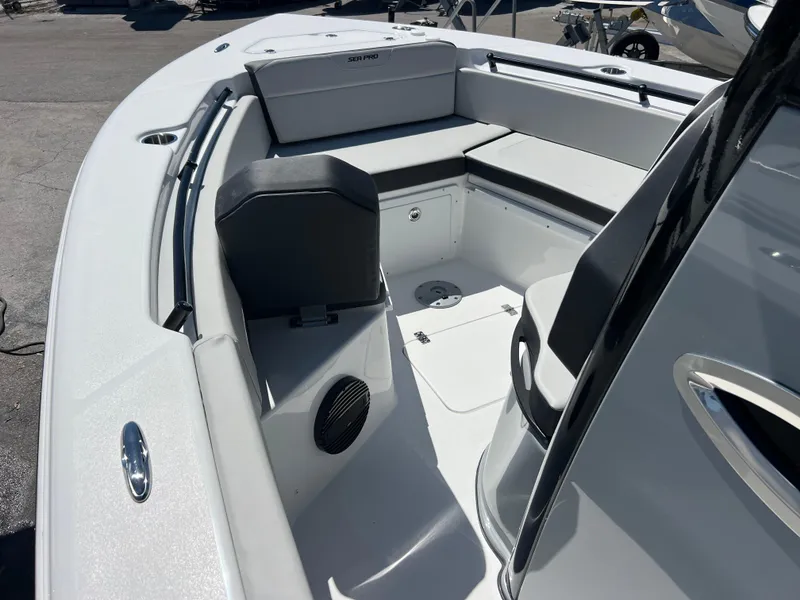 Slide: The Image of 2025 Sea Pro 245 FLX boat interior with seating and storage compartments. - 14