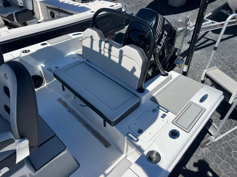 Slide: The Image of 2025 Sea Pro 245 FLX boat interior with seating and engine view. - 17