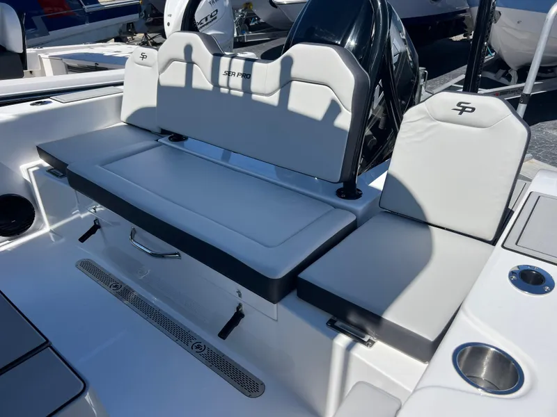 Slide: The Image of 2025 Sea Pro 245 FLX boat seating area with cushioned seats and cup holders. - 19