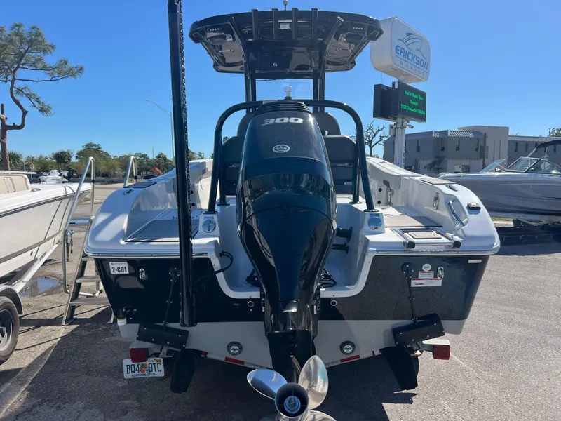 Slide: The Image of 2025 Sea Pro 245 FLX boat with powerful 300 HP engine, parked outdoors. - 7