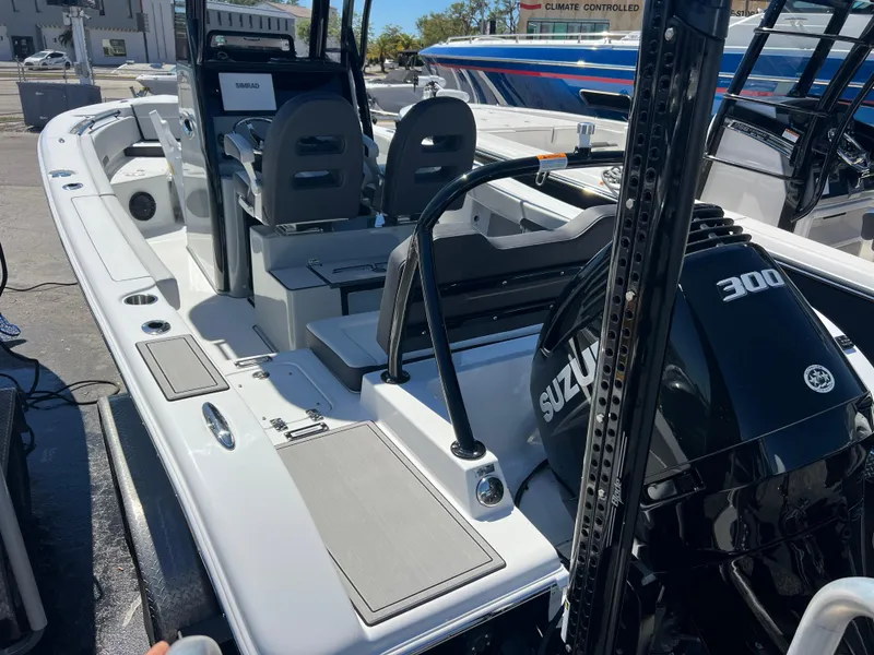 Slide: The Image of 2025 Sea Pro 245 FLX boat with Suzuki 300 engine, docked at marina. - 8