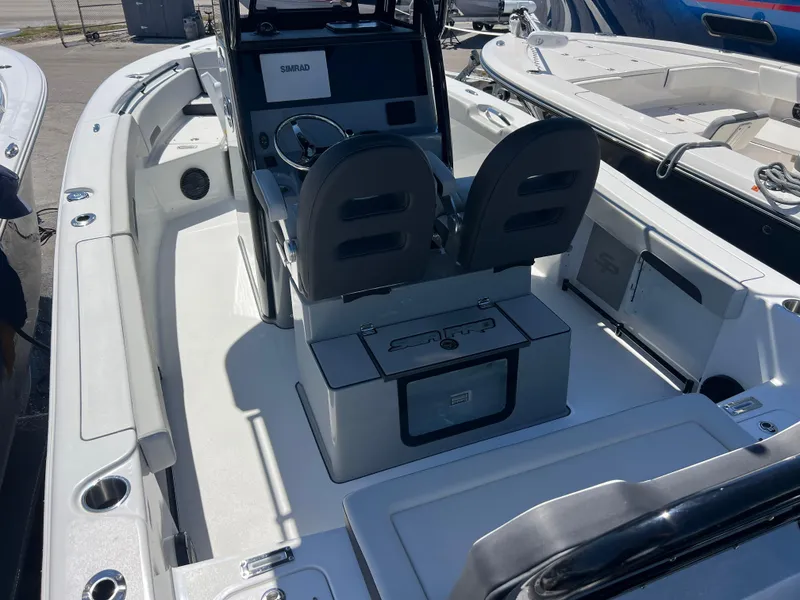 Slide: The Image of 2025 Sea Pro 245 FLX boat interior with dual seats and steering console. - 9