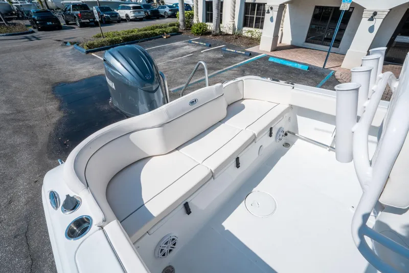 Slide: The Image of 2025 Sea Hunt Ultra 229 boat interior with seating and Yamaha engine in parking lot. - 11